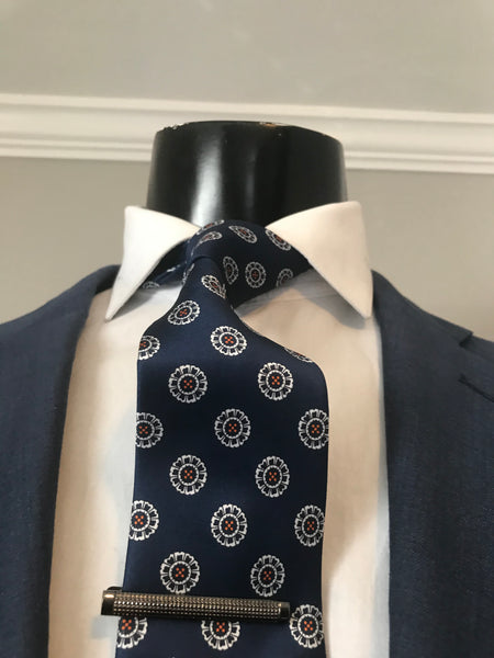 Dark blue and white with a splash of orange Tie set